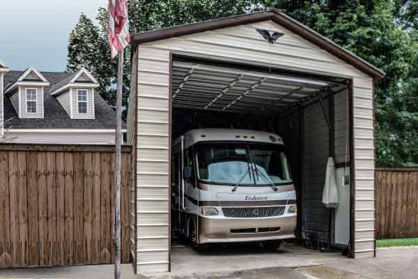 RV stored at home in an enclosed RV garage with roll up door