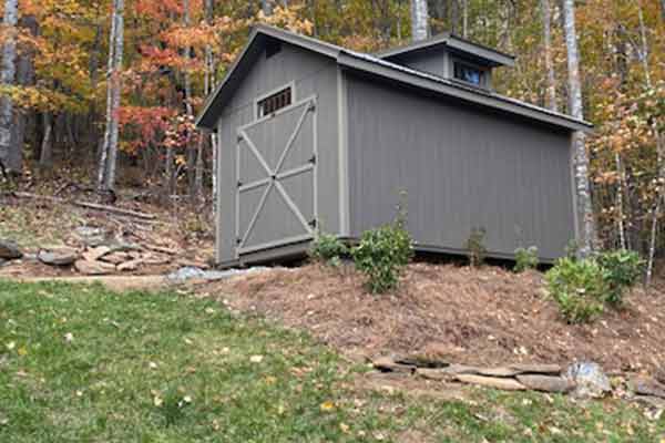 Natural Taupe Colored Shed is beautiful in nicely-landscaped area.